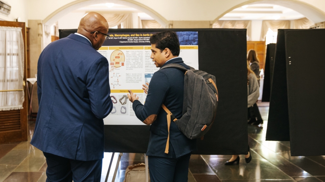 people talking at a poster presentation