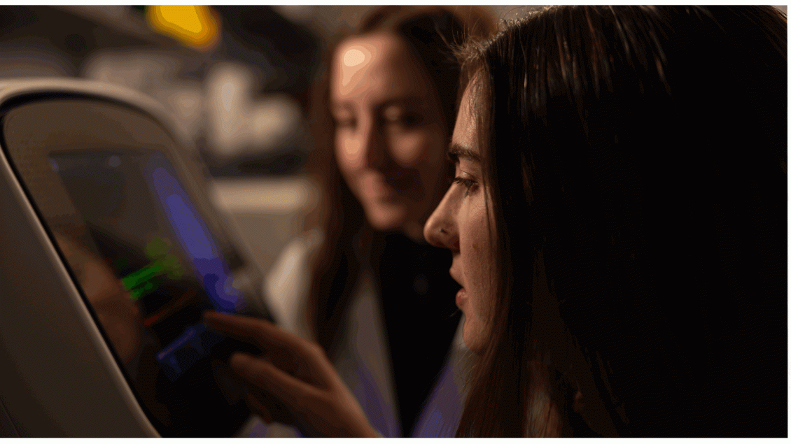 two female researchers look at a terminal screen