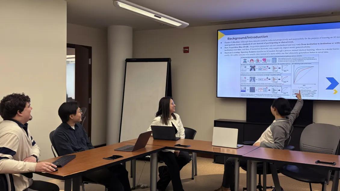 people in a conference room looking at a screen