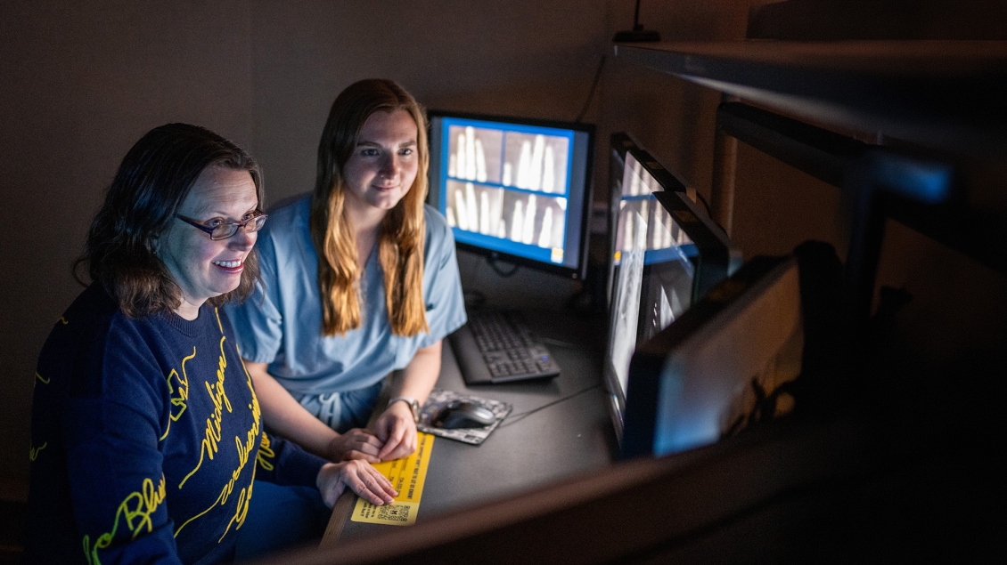 Radiology faculty teaching a resident in a reading room.
