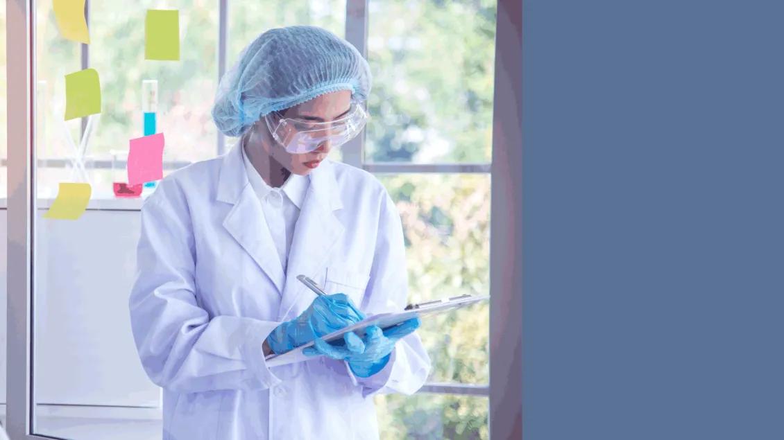 Scientist taking notes while standing
