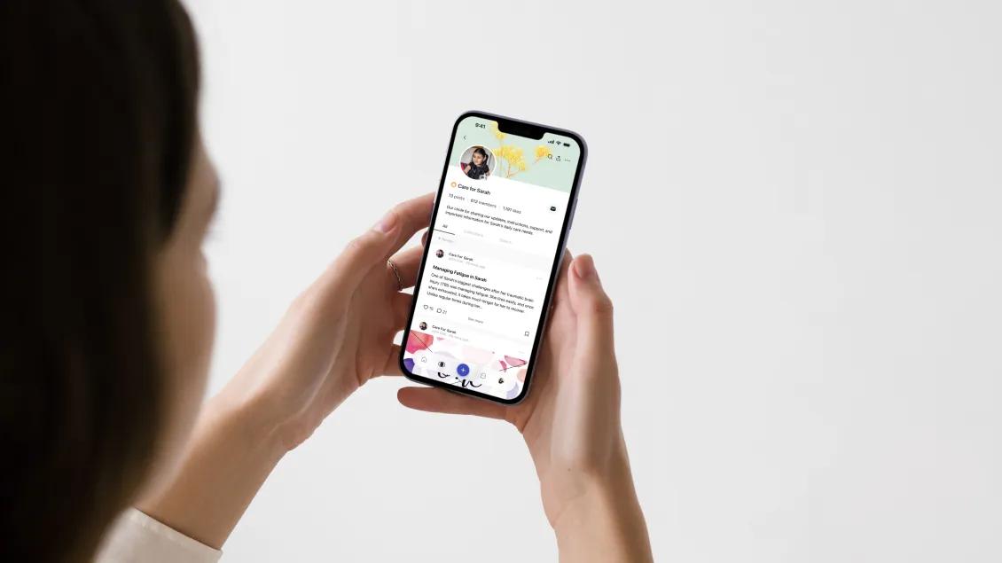 close-up of woman using CareCircle app on her phone