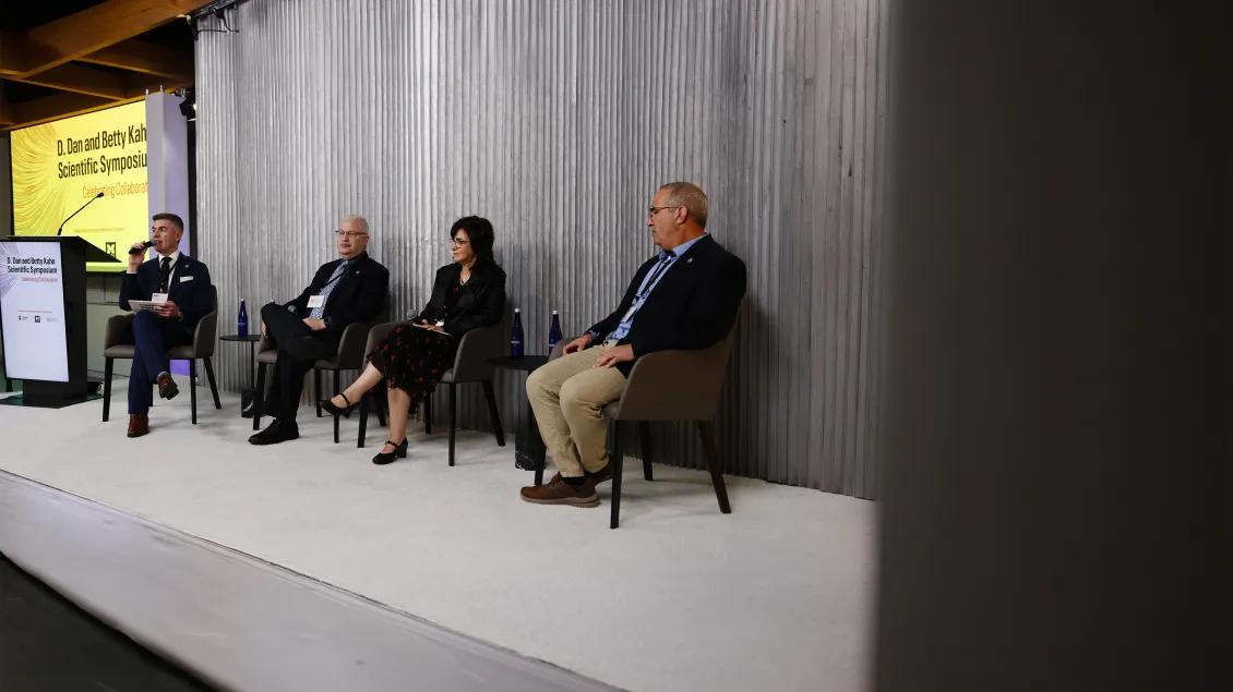 group of people on stage during a panel discussion