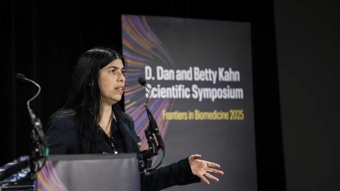 woman presenting at a symposium