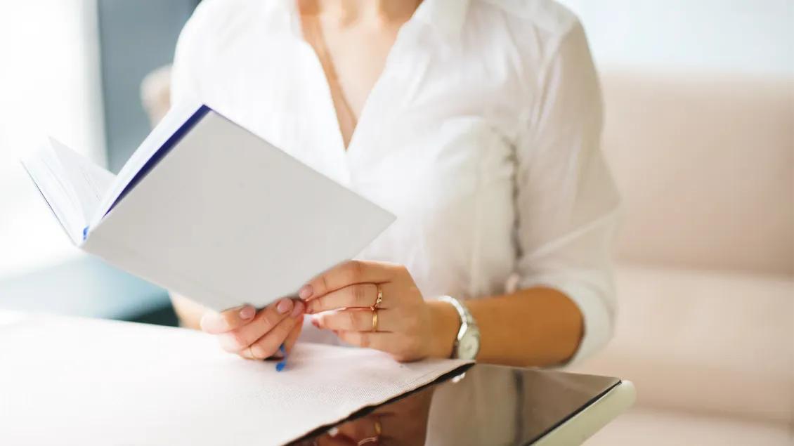 close-up of woman reading a book