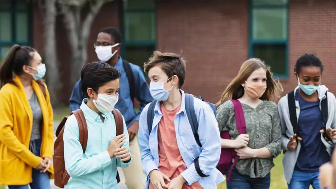 Children at school talking while walking with friends