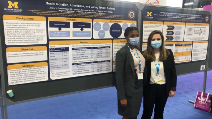 Researchers in front of their posters