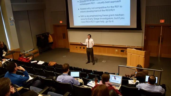 Faculty and Dr. Robertson in the auditorium at Palmer Commons