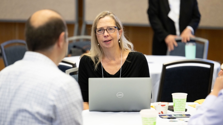 faculty talking to someone during a meeting or discussion