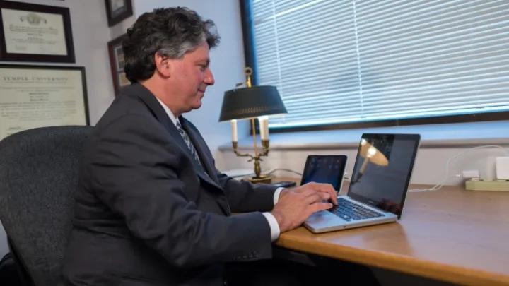 Man using a laptop in an office