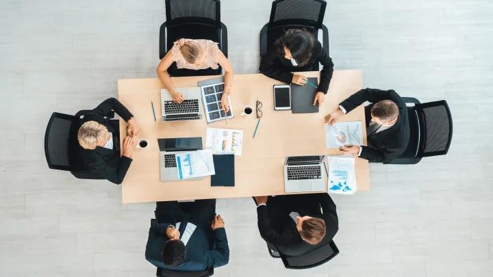 group in a meeting at a table seen from above