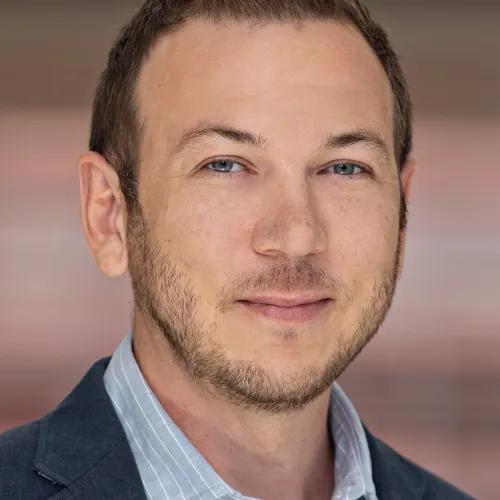 headshot of Adam Courtney