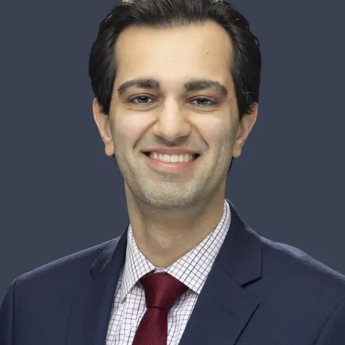 Smiling man in a dark suit with short dark hair