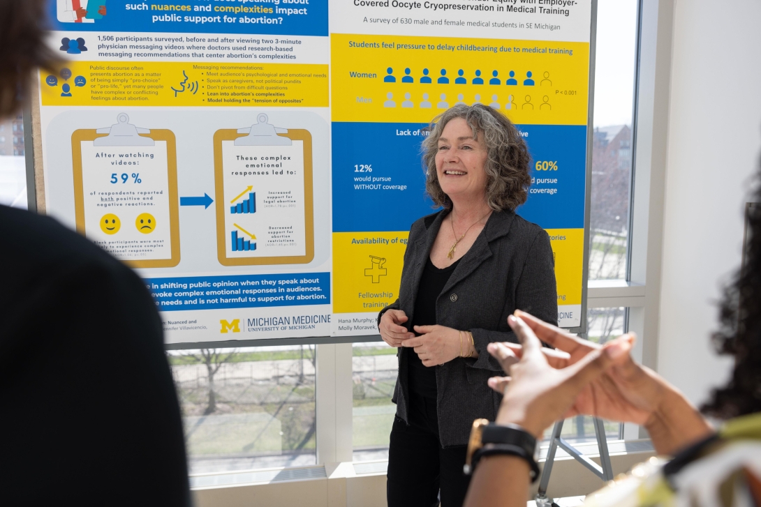  people listen to woman a while viewing content from obgyn posters from research day 