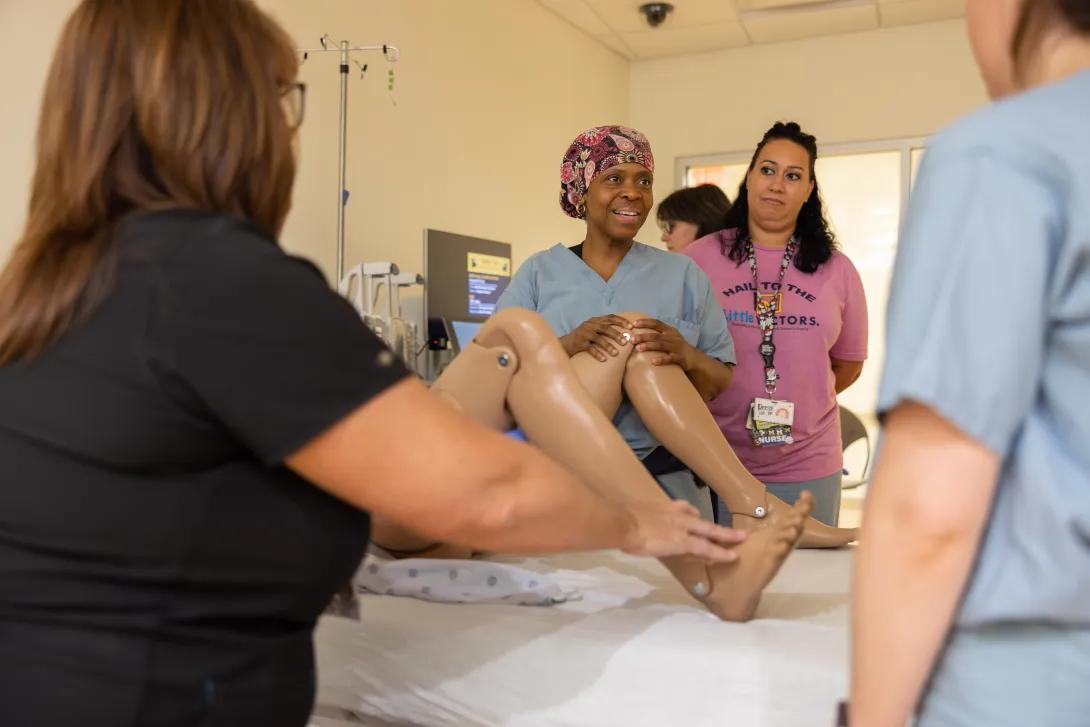 Doctor explains to students delivery techniques 