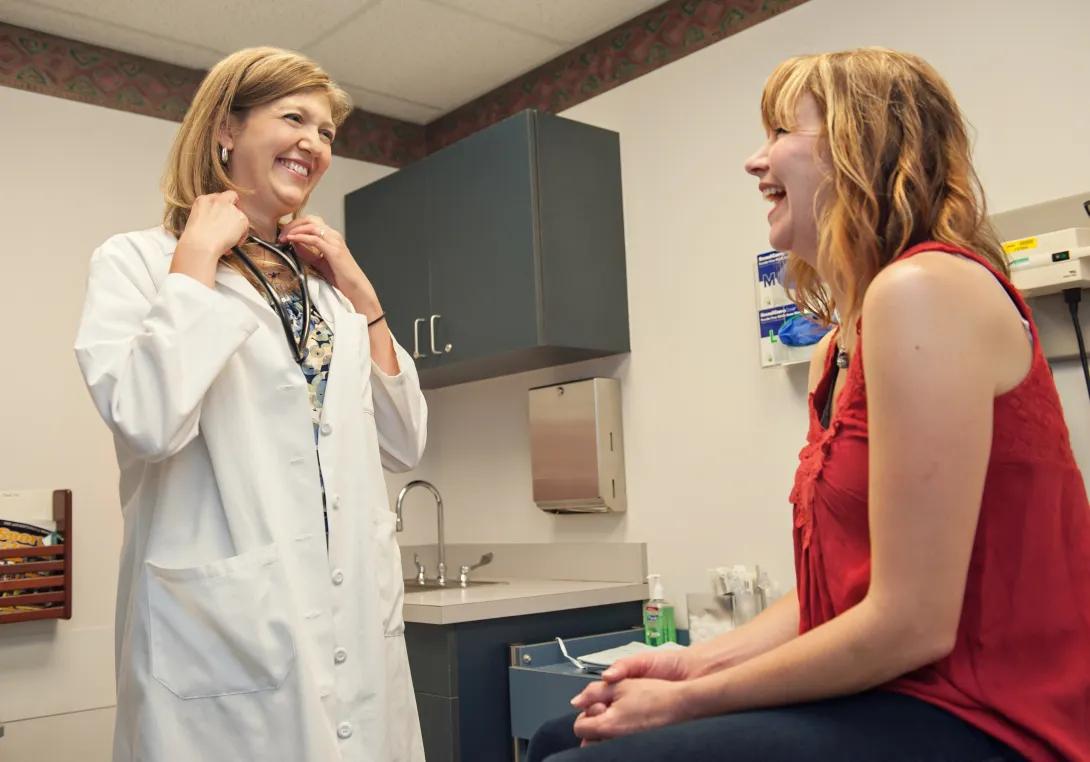 Dr Melinda Davis talking to patient in exam room 