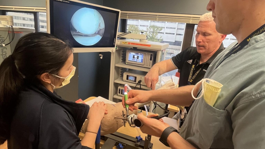 Student and professor learn how to use scope on patient during simulation 