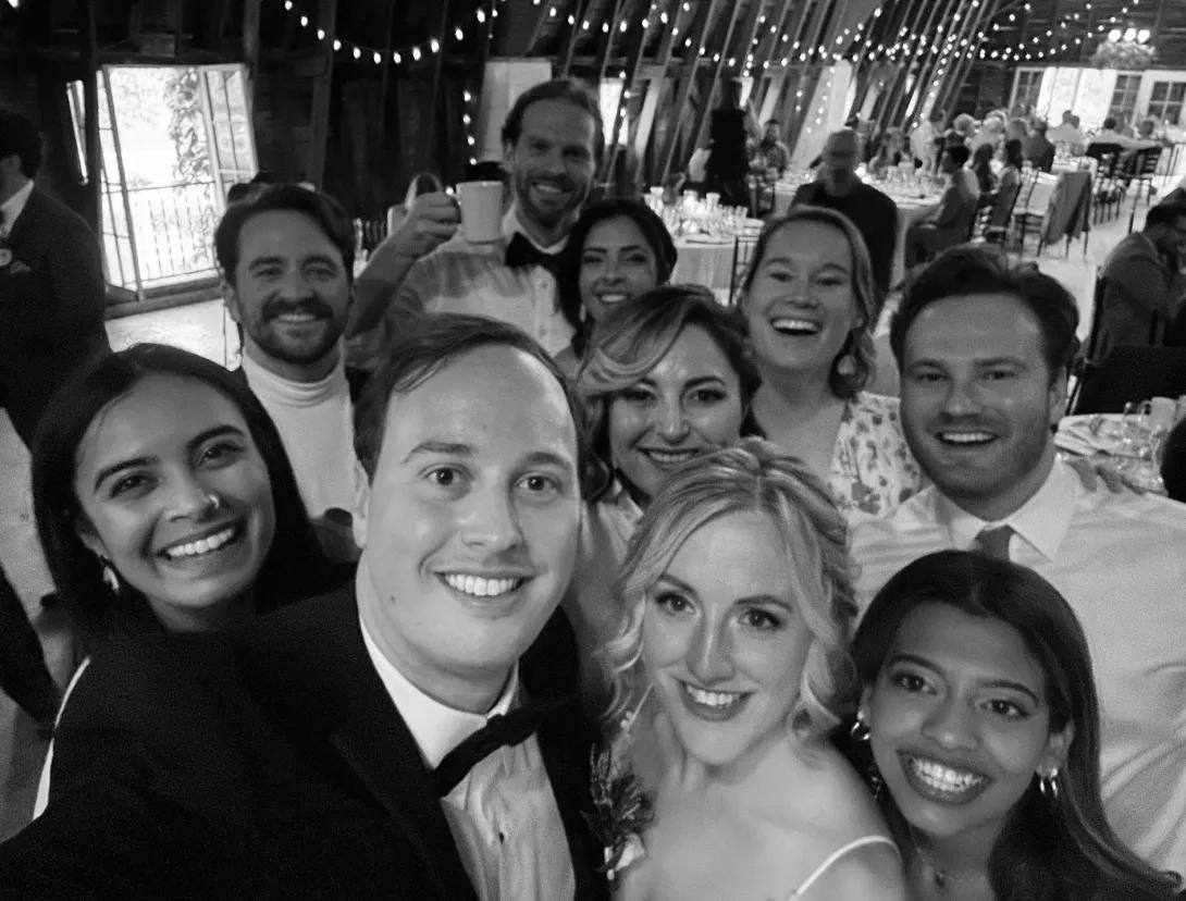 A black and white photo of a group of people at a wedding.