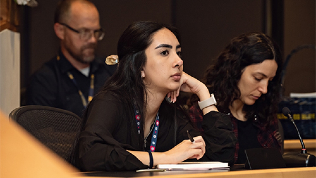 Two women and a man listening during Annual M-BoCA Symposium.