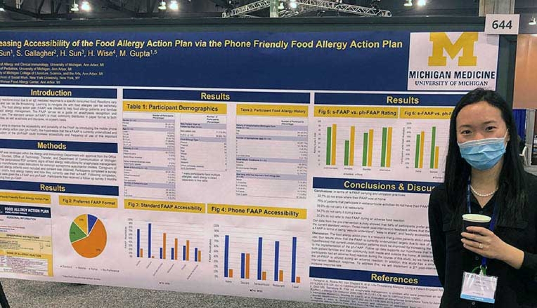 Fellow standing next to poster on food allergy data