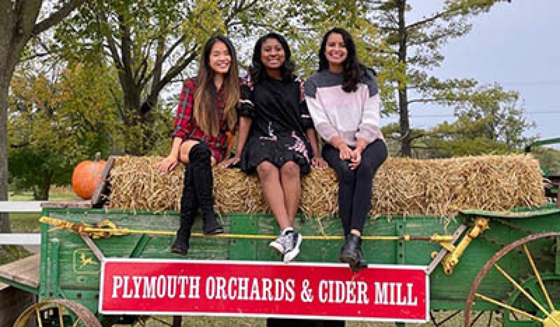 Three women at a hayride and cider mill