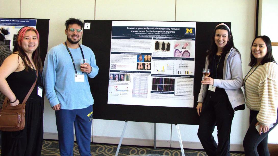 CDB students standing next to a poster