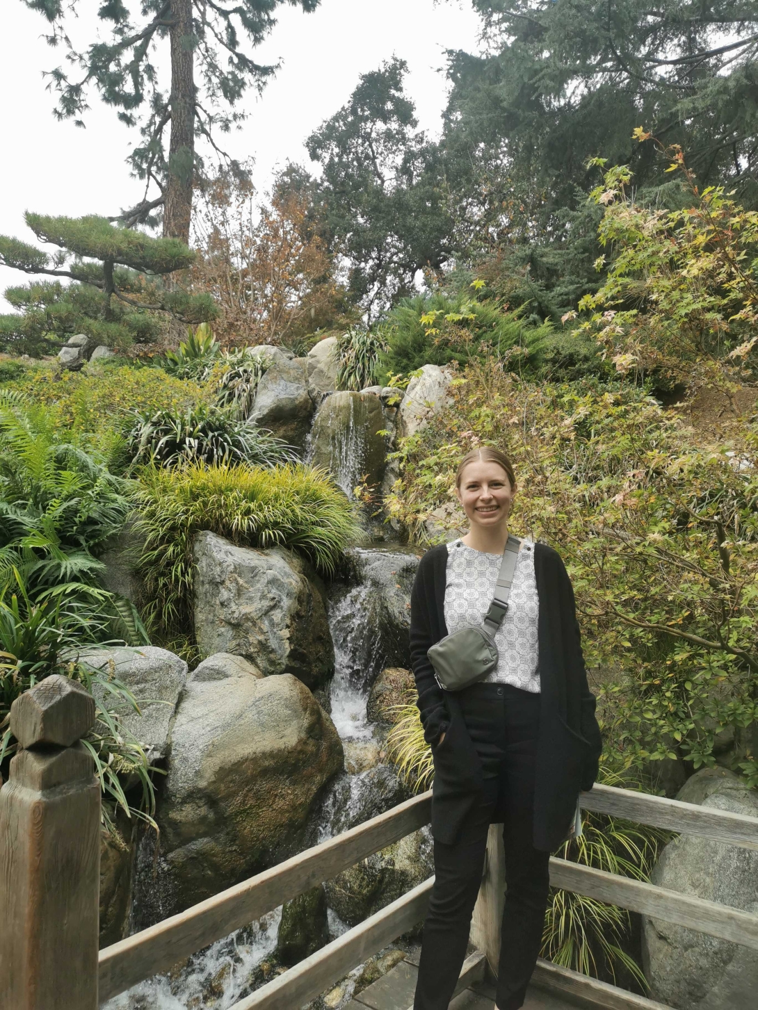 Female member with trees as landscape posing for a photo