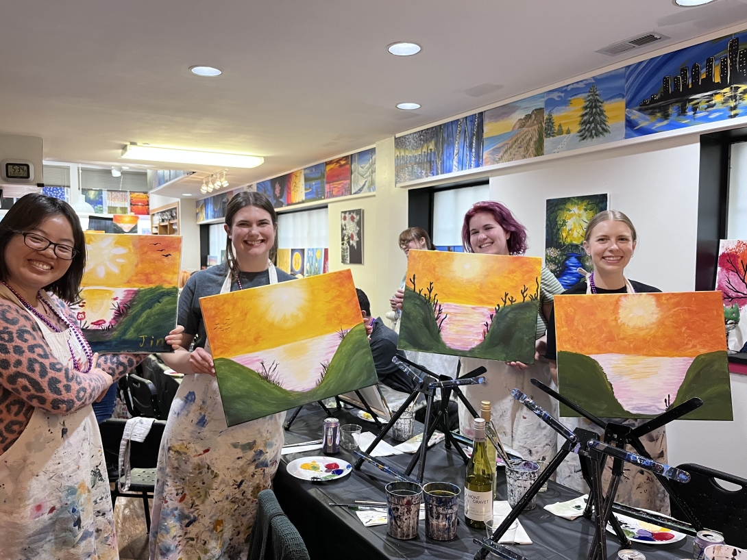 Lab members holding their artwork for photo