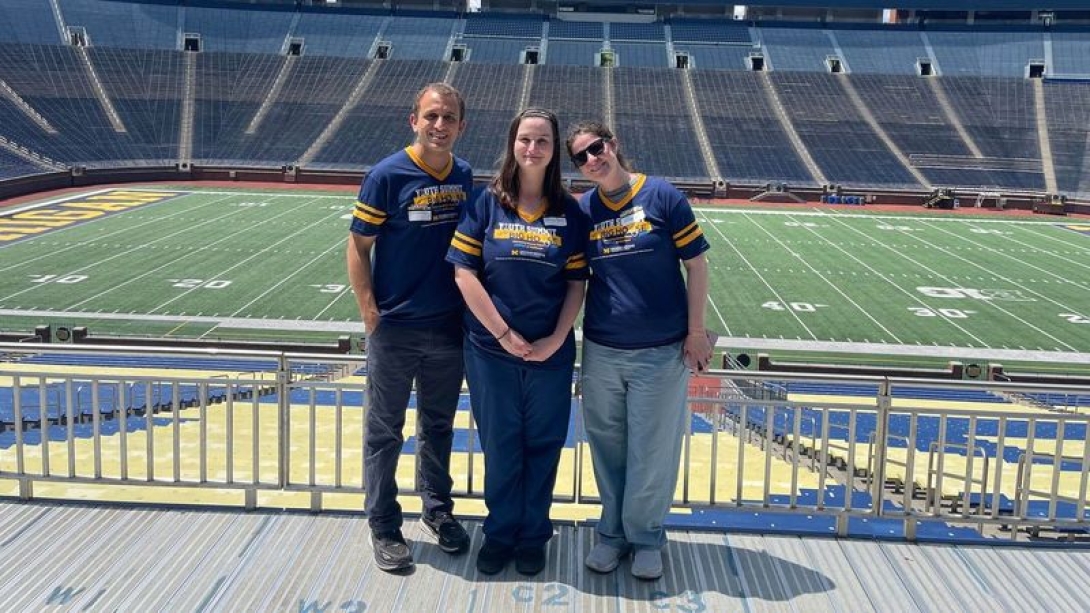 Three people on a football field