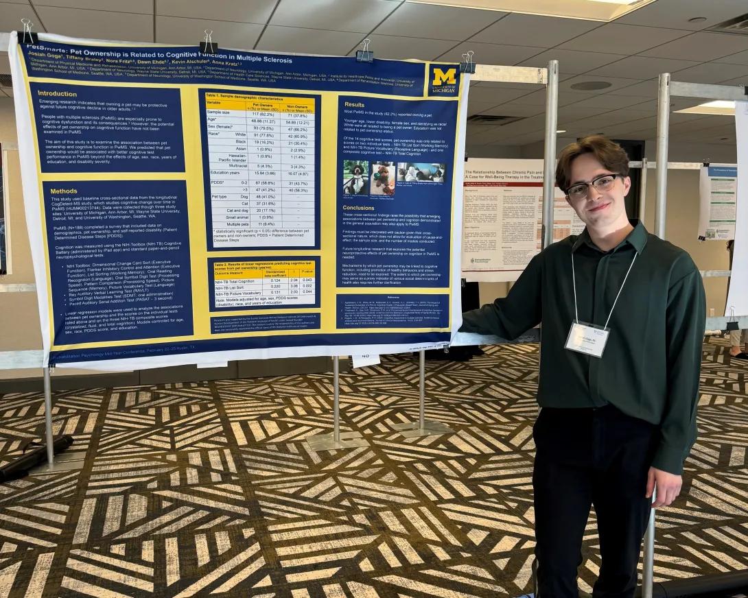 lab member showcasing a poster at a conference
