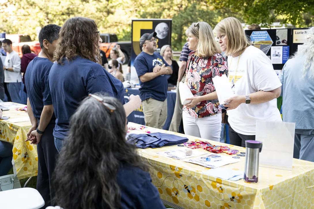 people talking at table at outdoor event