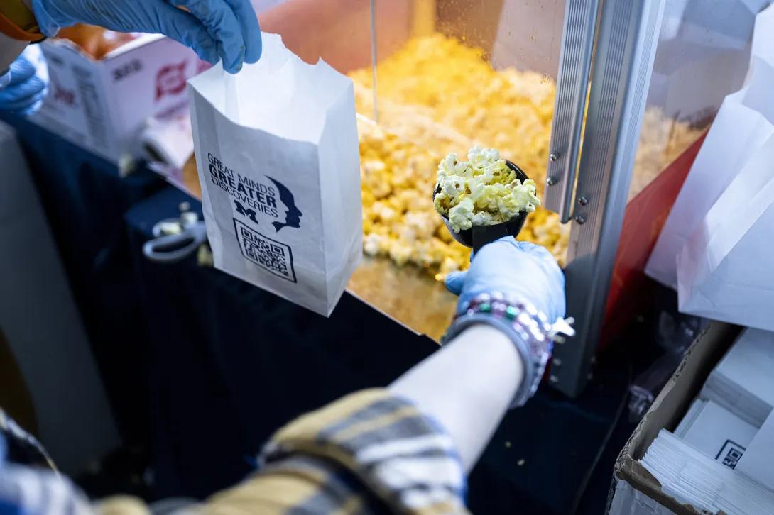 close-up of person scooping popcorn