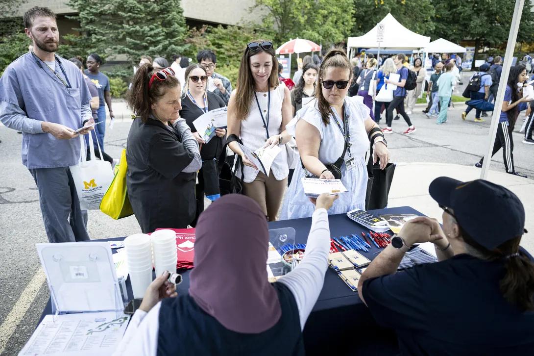 people talking at table at outdoor event