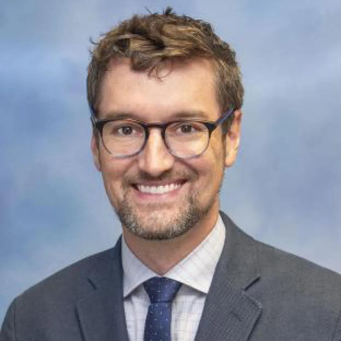 portrait of Kyler Mulhauser, PhD