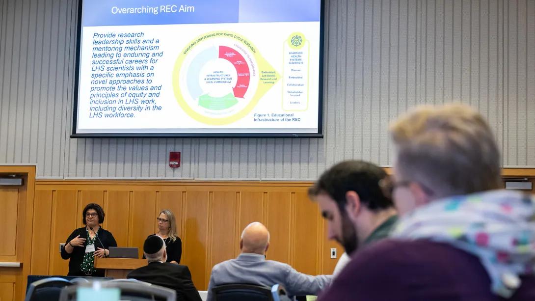 Symposium attendees listening to a presentation