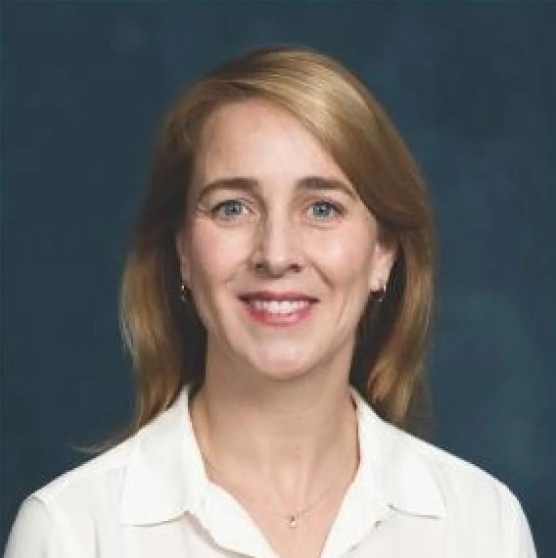 a woman with blonde hair and a white shirt