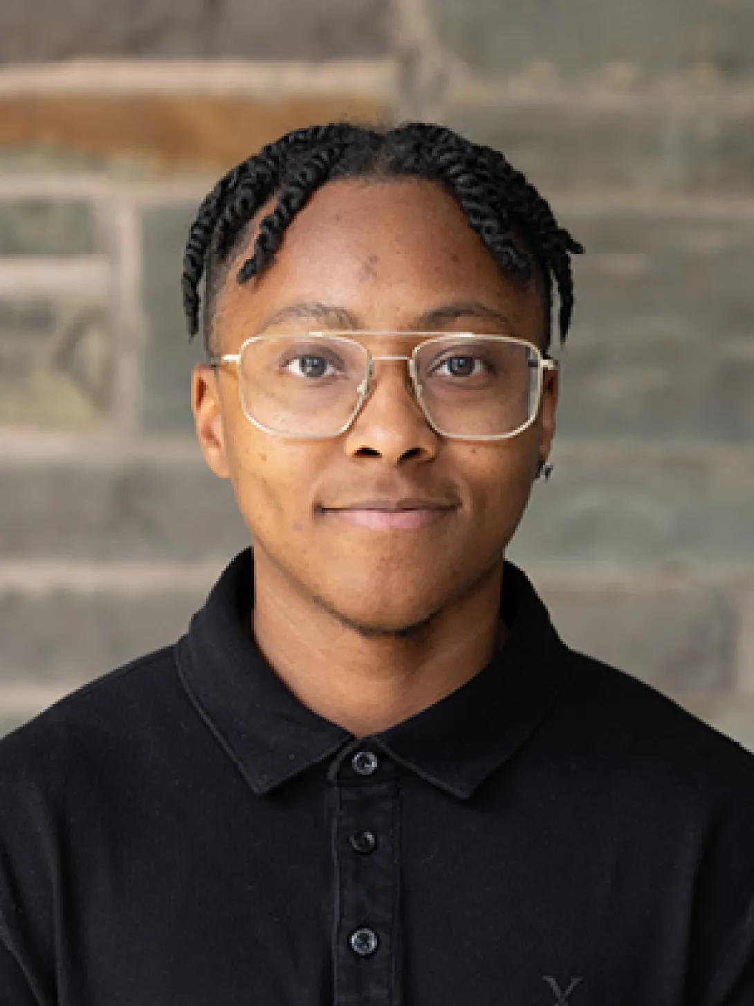 a young Black man with glasses 