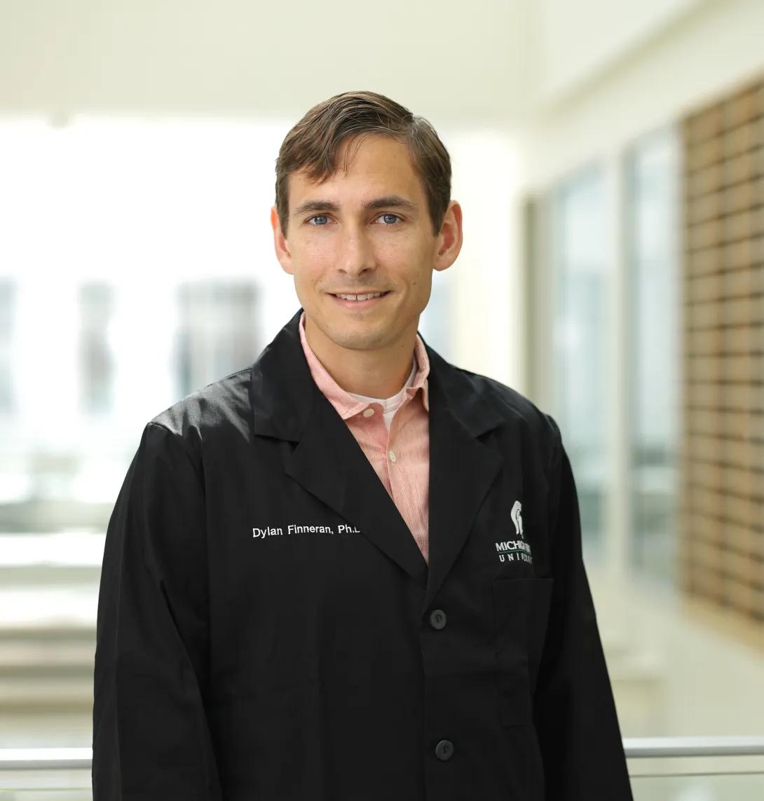 a man with blonde hair and a lab coat 