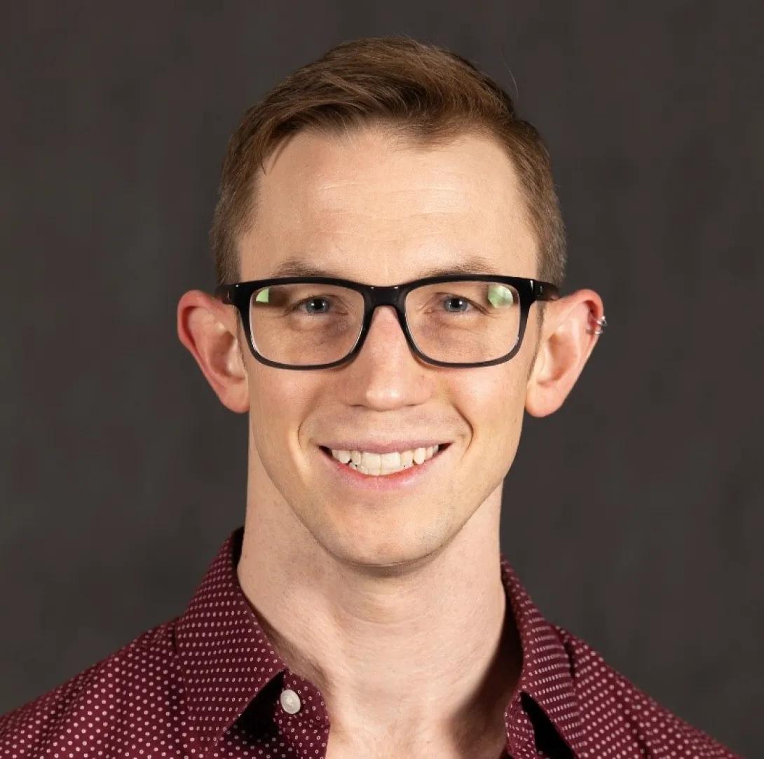 a man with red hair and glasses 