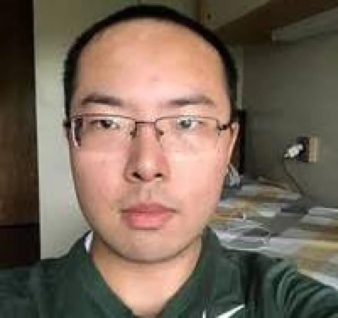 an Asian man with glasses 