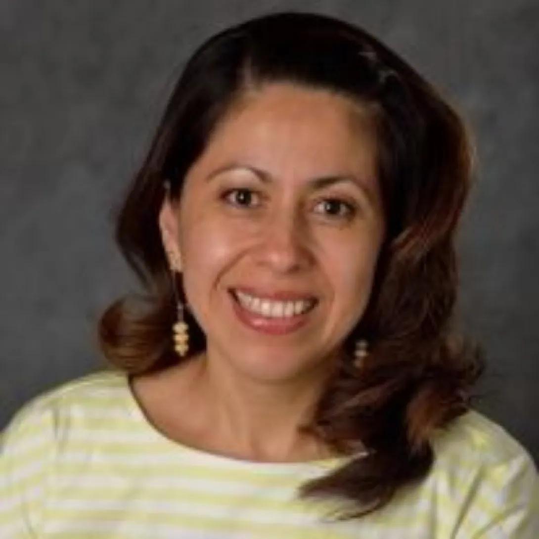 a Hispanic woman with brown hair 
