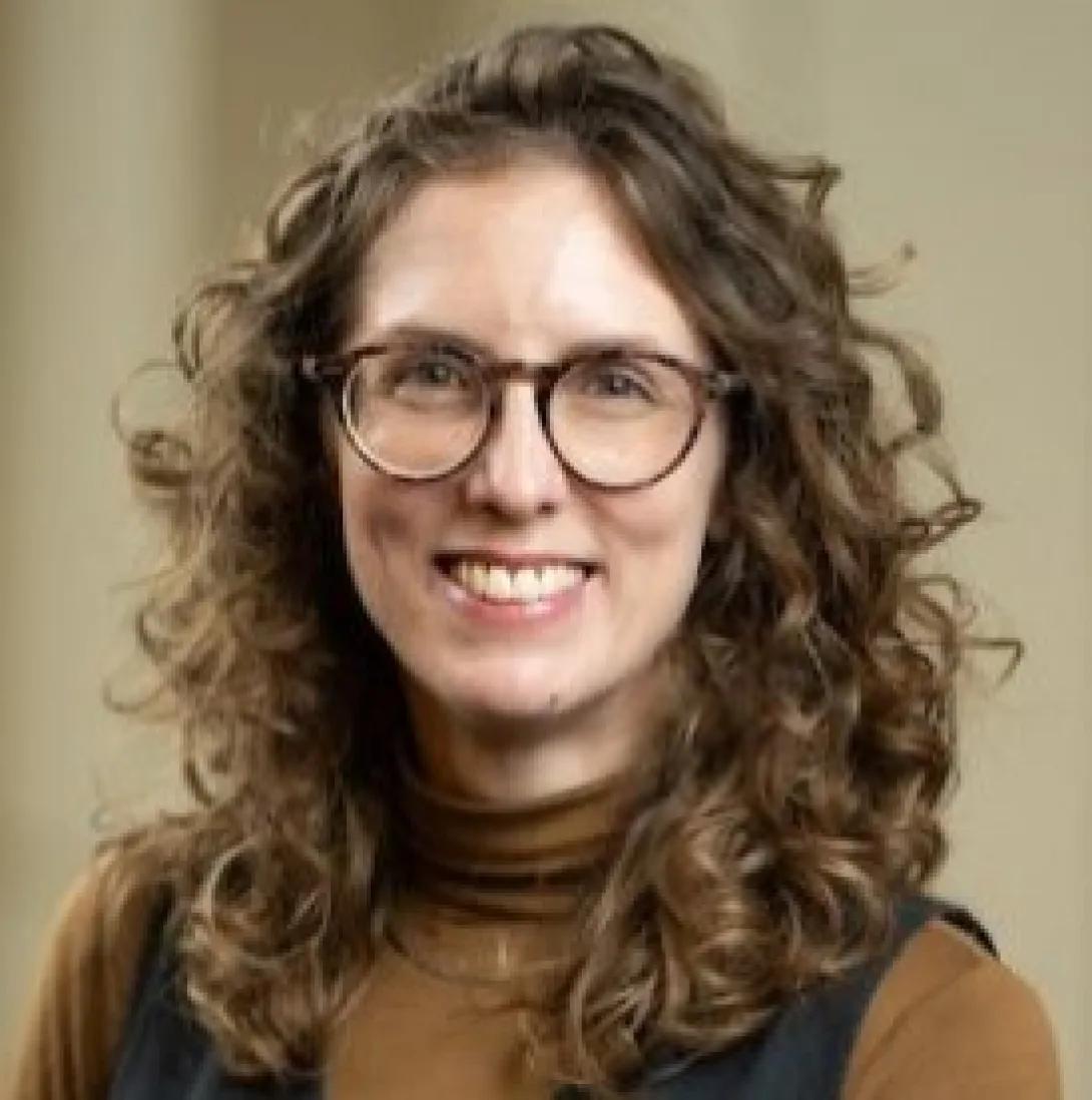 a woman with curly brown hair