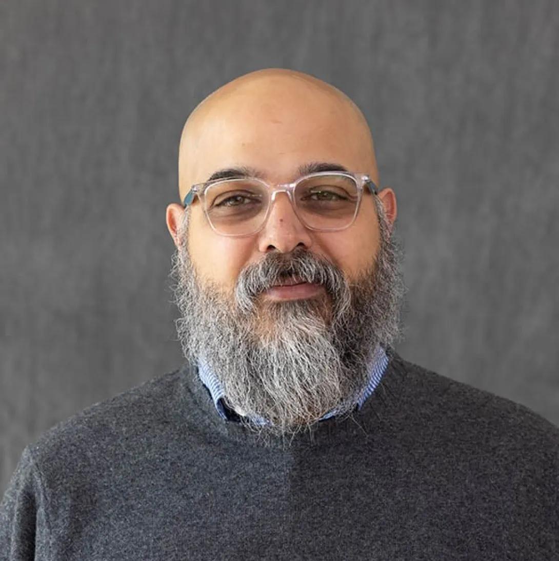 a bald Middle Eastern man with a beard 