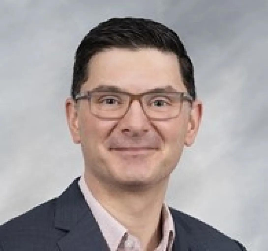 a man with brown hair and glasses 