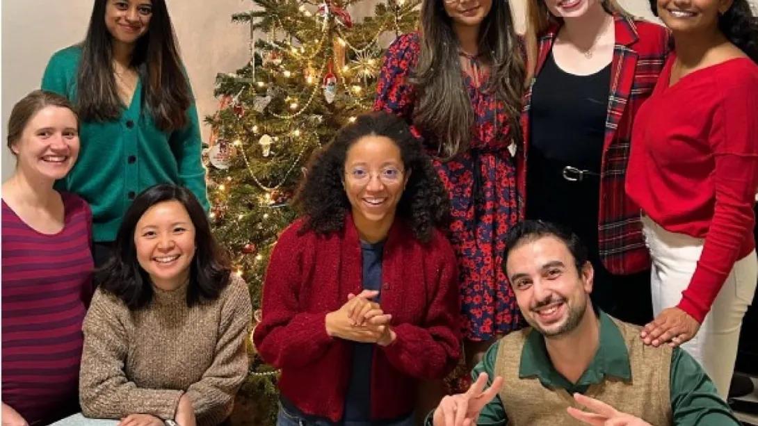 Psychiatry residents celebrating the holidays in front of the Christmas tree