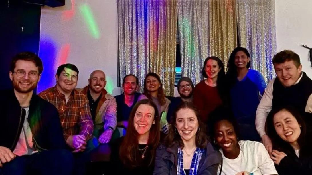 Thirteen psychiatry residents pose in karaoke room.
