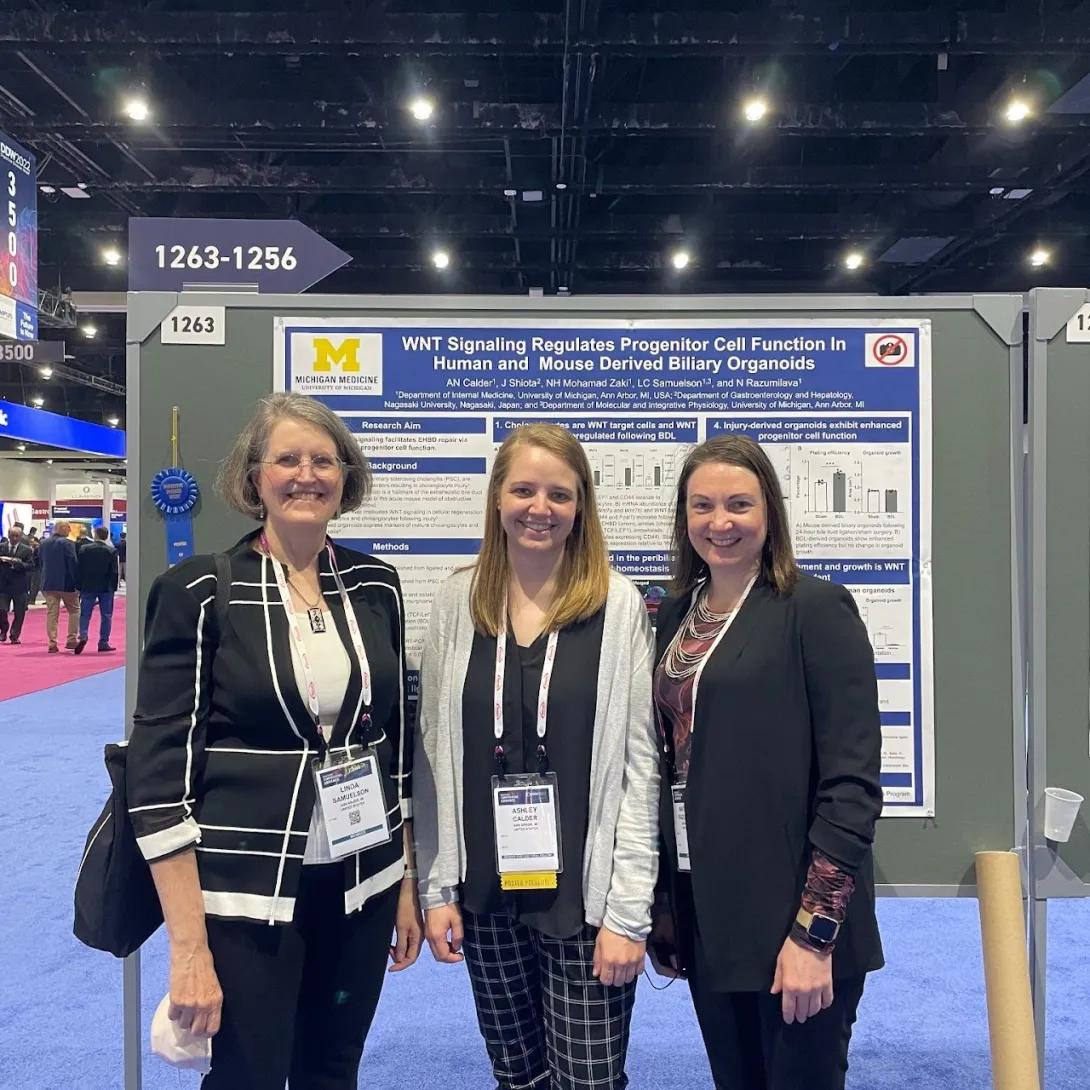 Team members in front of research poster
