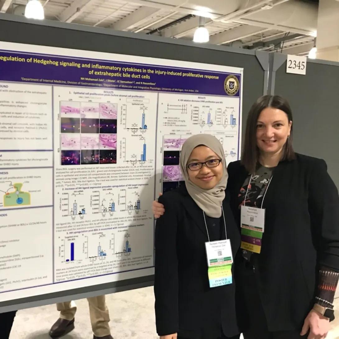 Dr. Razumilava and Nureen in front of research poster
