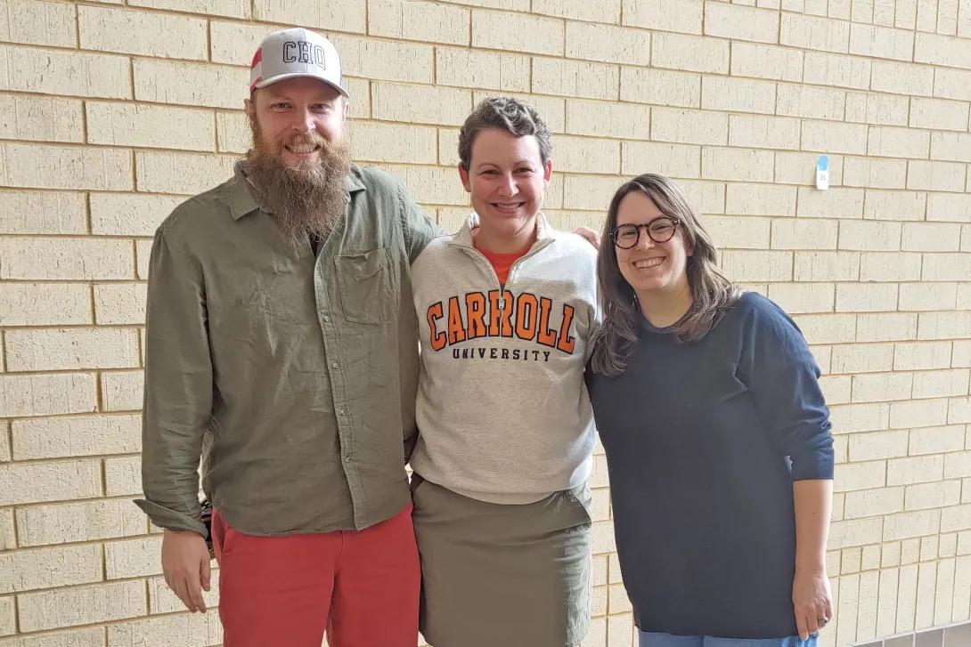 Three smiling people
