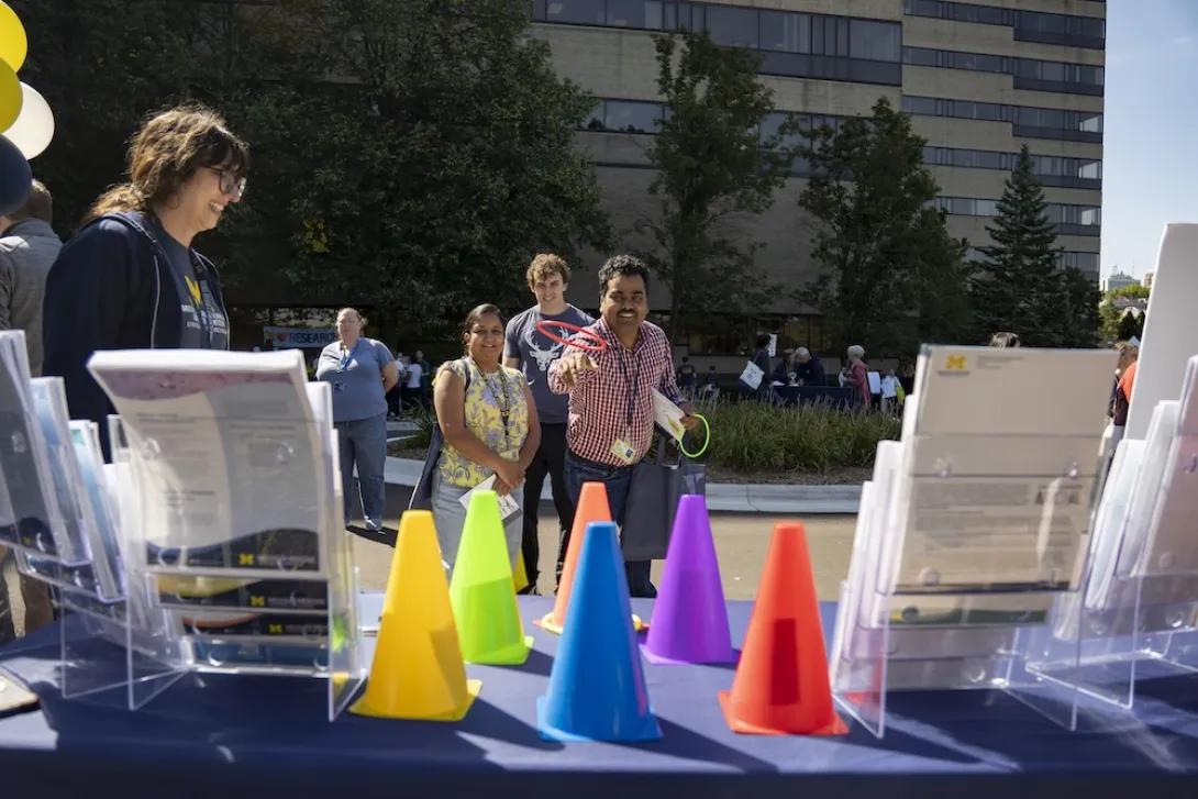 Man playing ring toss game at Researchpalooza